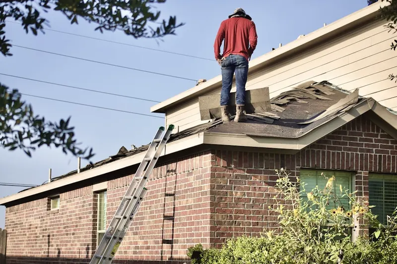 Professional roofer working on a residential roof in Belcamp